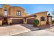 Stunning two-story stucco home boasts a three-car garage and a charming tile roof under a beautiful blue sky at 5370 S Desert Dawn Dr # 39, Gold Canyon, AZ 85118