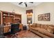 Comfortable home office with a desk, shelving, a ceiling fan, and a sofa at 5370 S Desert Dawn Dr # 39, Gold Canyon, AZ 85118