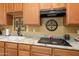 Well-lit kitchen featuring granite countertops, wood cabinets, and a ceramic cooktop at 5370 S Desert Dawn Dr # 39, Gold Canyon, AZ 85118