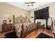 Ornate main bedroom featuring a decorative bedframe, dark window treatments, and hardwood floors at 5370 S Desert Dawn Dr # 39, Gold Canyon, AZ 85118