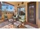 Covered patio with comfortable seating, decorative lanterns, and a view of lush greenery at 5370 S Desert Dawn Dr # 39, Gold Canyon, AZ 85118