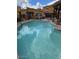 Community pool and hot tub surrounded by resort-style seating and manicured landscaping at 5370 S Desert Dawn Dr # 39, Gold Canyon, AZ 85118
