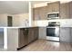 Modern kitchen featuring gray cabinetry, stainless steel appliances, and a large island with a sink at 5981 N Nigal Rd, Casa Grande, AZ 85194