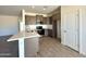 Open-concept kitchen with sleek gray cabinets, modern appliances, and a spacious island for entertaining at 5981 N Nigal Rd, Casa Grande, AZ 85194