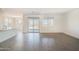 Bright and airy living room featuring modern gray floors, large windows, and an open layout at 5981 N Nigal Rd, Casa Grande, AZ 85194