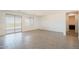Bright, open living room with sliding glass doors, a large window, and tile floors at 5981 N Nigal Rd, Casa Grande, AZ 85194