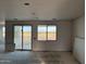 Partially finished living room with drywall and sliding glass doors, highlighting natural light and outdoor access at 5981 N Nigal Rd, Casa Grande, AZ 85194