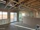 Spacious living room under construction features exposed beams and studs with large windows at 5981 N Nigal Rd, Casa Grande, AZ 85194