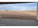 View from a covered patio showcasing the expansive desert landscape with a mountain in the distance at 5981 N Nigal Rd, Casa Grande, AZ 85194