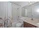 Cozy bathroom featuring a shower-tub combo, floral shower curtain, and vanity with a granite countertop at 7044 W Sierra St, Peoria, AZ 85345