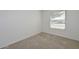 Bright bedroom featuring a window with blinds, neutral carpet flooring and white walls at 7044 W Sierra St, Peoria, AZ 85345