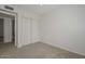 Bedroom with white walls, neutral carpet, a window with blinds and a double-door closet at 7044 W Sierra St, Peoria, AZ 85345