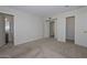 Large bedroom with neutral carpet and an ensuite bathroom with two closets at 7044 W Sierra St, Peoria, AZ 85345
