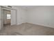 Bedroom with neutral carpet and white walls with a doorway leading into another room at 7044 W Sierra St, Peoria, AZ 85345
