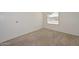 Bedroom with white walls, neutral carpet, a window with blinds and a closet at 7044 W Sierra St, Peoria, AZ 85345