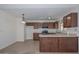 Traditional kitchen featuring wood cabinetry, stainless steel appliances, and a breakfast bar at 7044 W Sierra St, Peoria, AZ 85345