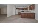 Open-concept kitchen featuring tile flooring, breakfast bar, and access to the living area at 7044 W Sierra St, Peoria, AZ 85345
