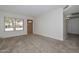Open-plan living room showcasing large windows and a front door entry at 7044 W Sierra St, Peoria, AZ 85345