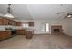 Bright open-concept layout with a kitchen, living area with fireplace and access to the exterior at 7044 W Sierra St, Peoria, AZ 85345