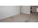 Spacious living room showcasing neutral carpet, with transition to tile and kitchen at 7044 W Sierra St, Peoria, AZ 85345
