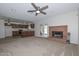 Open concept living room with a brick fireplace and seamless access to the kitchen at 7044 W Sierra St, Peoria, AZ 85345