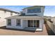 Backyard view of house featuring covered patio, dark windows, and gravel at 7449 W Buckhorn Trl, Peoria, AZ 85383