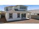 Backyard view of house featuring covered patio, dark windows, and gravel at 7449 W Buckhorn Trl, Peoria, AZ 85383