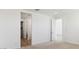 Bright bedroom offers neutral carpet and an open doorway at 7449 W Buckhorn Trl, Peoria, AZ 85383