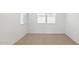 Bedroom features a neutral carpet and natural light from a window at 7449 W Buckhorn Trl, Peoria, AZ 85383