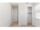 Freshly painted bedroom with an open door, closet with sliding doors, and window with blinds at 7449 W Buckhorn Trl, Peoria, AZ 85383