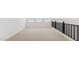 Hallway features a neutral carpet, black metal railing, and natural light from three windows at 7449 W Buckhorn Trl, Peoria, AZ 85383