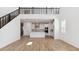 Open-concept living room with a kitchen and staircase, perfect for entertaining at 7449 W Buckhorn Trl, Peoria, AZ 85383
