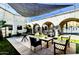 Inviting community patio featuring tables and seating with views of the pool and a shaded area with string lights at 7950 E Camelback Rd # 211, Scottsdale, AZ 85251