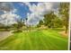 Scenic view of lush greenspace with a tranquil pond and mature trees at 7950 E Camelback Rd # 211, Scottsdale, AZ 85251