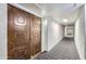 Long hallway featuring textured walls and geometric carpeting leading to the unit entrance at 7950 E Camelback Rd # 211, Scottsdale, AZ 85251