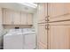 Bright laundry area with a washer and dryer, convenient upper cabinets, and lots of storage at 7950 E Camelback Rd # 211, Scottsdale, AZ 85251