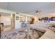 Open concept living area with a neutral color palette, bar seating, and adjacent kitchen at 7950 E Camelback Rd # 211, Scottsdale, AZ 85251