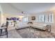 Bright living room with a plush sectional sofa, neutral carpet, and sliding doors to balcony at 7950 E Camelback Rd # 211, Scottsdale, AZ 85251