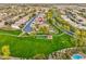 Aerial view of the community showcases green spaces, a playground, a pavilion, pools, and residential streets at 835 E Virgo Pl, Chandler, AZ 85249