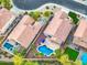 A bird's-eye view of homes with pools, patios, and lush backyards in a tranquil neighborhood at 835 E Virgo Pl, Chandler, AZ 85249