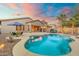 Resort-style backyard with a sparkling pool, covered patio, and lush landscaping at 835 E Virgo Pl, Chandler, AZ 85249