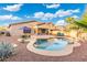 Large backyard pool and patio area with desert landscaping, complete with an umbrella and lounge chairs at 835 E Virgo Pl, Chandler, AZ 85249
