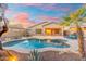 Stunning backyard pool with patio, outdoor seating, desert landscaping, and beautiful sunset at 835 E Virgo Pl, Chandler, AZ 85249
