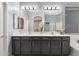 Bright bathroom featuring a double vanity with modern fixtures, framed mirror, and neutral color palette at 835 E Virgo Pl, Chandler, AZ 85249