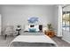 Cozy bedroom with a stylish patterned comforter, neutral decor, and view of the backyard at 835 E Virgo Pl, Chandler, AZ 85249