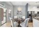 Cozy dining area with a round table, elegant chairs, and stainless steel refrigerator at 835 E Virgo Pl, Chandler, AZ 85249