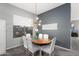 Dining room features an oval wood table, contemporary lighting, and seating for six at 835 E Virgo Pl, Chandler, AZ 85249