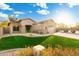 Beautifully landscaped single-story home with lush green lawn, mature trees, and a two-car garage at 835 E Virgo Pl, Chandler, AZ 85249