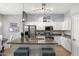 Modern kitchen with white cabinets, stainless steel appliances, and stylish lighting fixtures above the kitchen island at 835 E Virgo Pl, Chandler, AZ 85249