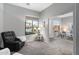 Spacious living room featuring a comfortable recliner, large windows, and neutral tones at 835 E Virgo Pl, Chandler, AZ 85249